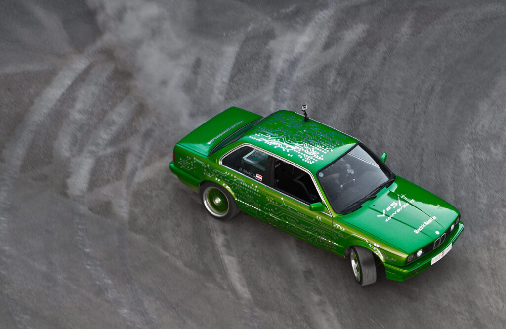 green bmw car drifting on race track