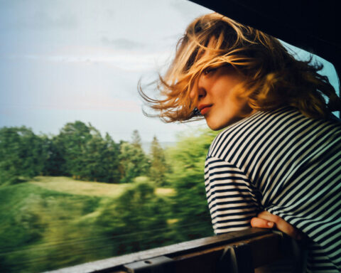 Woman looking at the view from train