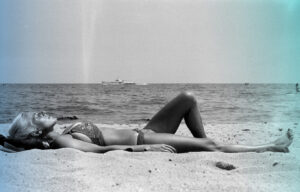 woman lay on sand on beach