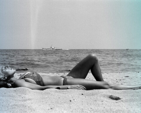woman lay on sand on beach
