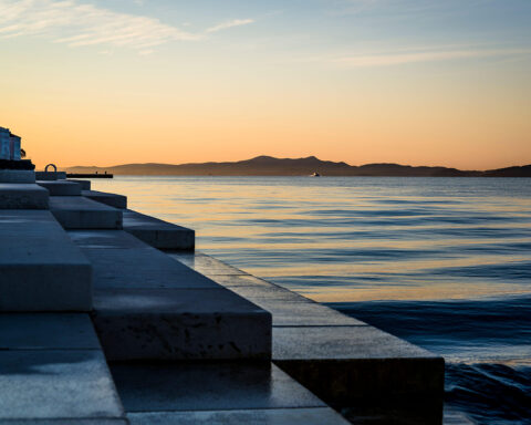 The Sea organ at sunrise, an architectural sound art object which plays music by way of sea waves and tubes located underneath a set of large marble