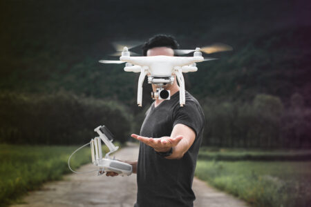 Drone is taking off from man hands. Young man releasing aerial copter to fly with small digital camera. Modern technology in our life.