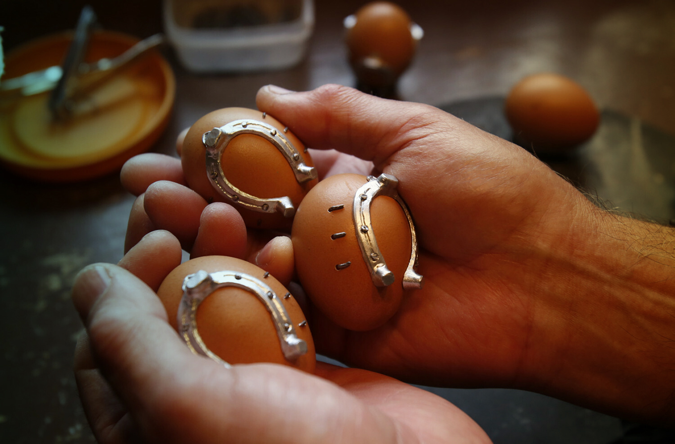 eggs with a horseshoe in hands