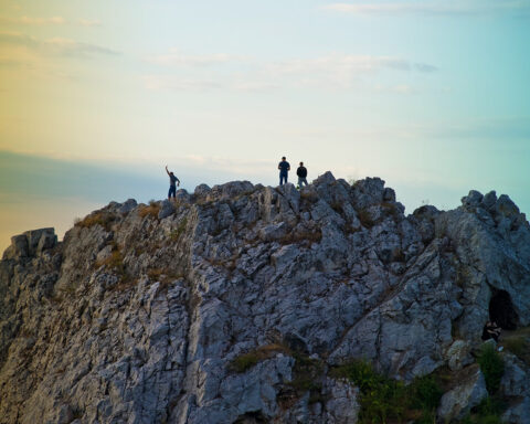 people standing on to of a limestone rock in Kadzielnia nature reserve in Kielce Swietokrzyskie Voivodeship Poland