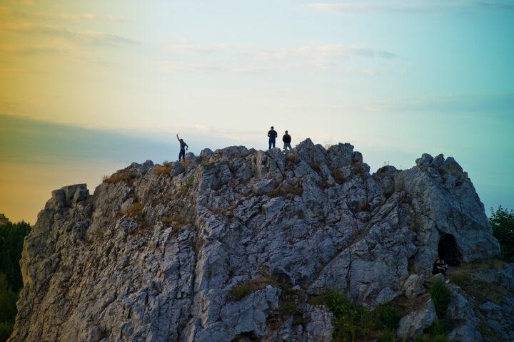 people standing on to of a limestone rock in Kadzielnia nature reserve in Kielce Swietokrzyskie Voivodeship Poland