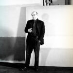 Aritst mark Rothko standing in front of his paintings