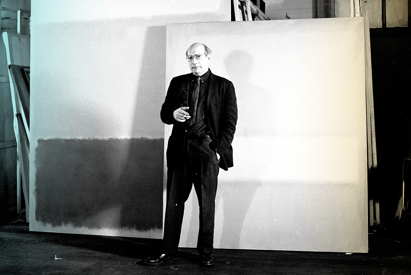 Aritst mark Rothko standing in front of his paintings