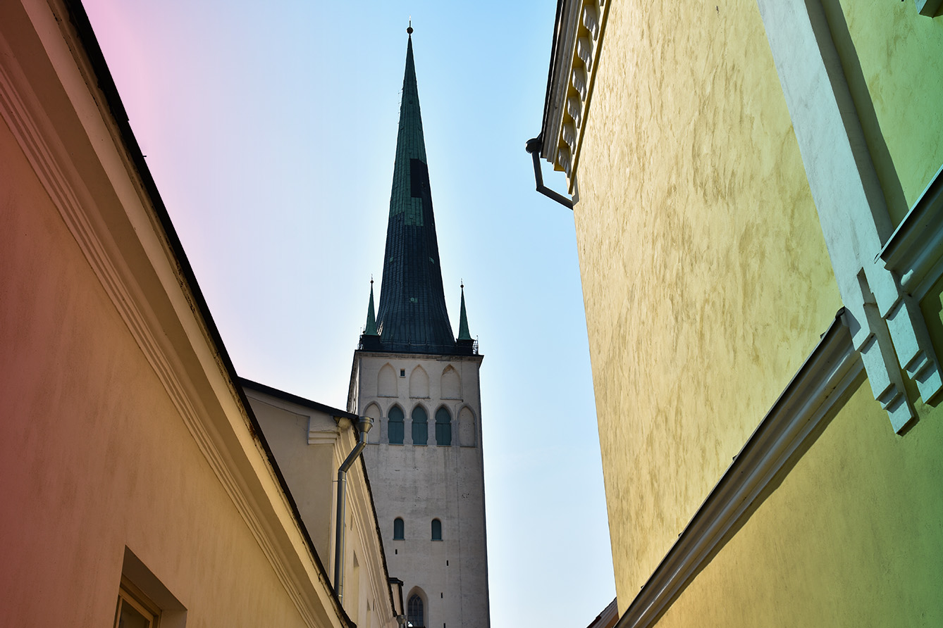 Top part of the tower of St. Olaf's Church in Tallinn, Estonia view from the alley