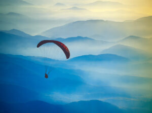 parachutes silhouette in a light of sunrise