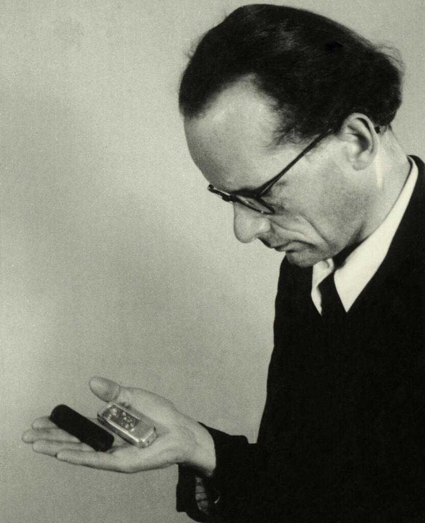 Walter zapp holding minox camera in hand