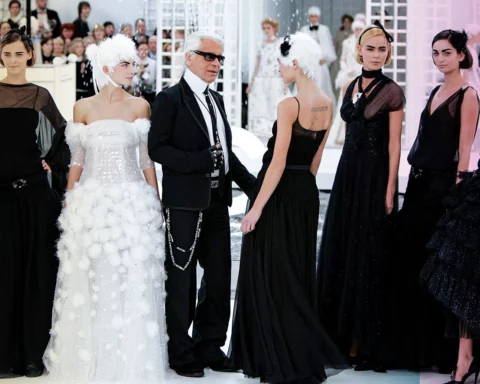Carmen Kass and Karl Lagerfeld walk the runway during the Chanel Haute Couture