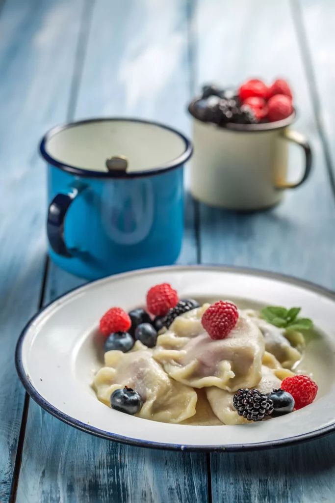 Delicious dumplings with blueberry, blackberry and raspberry