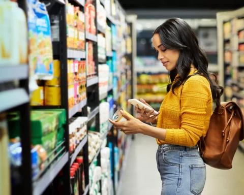 Shot of a young woman shopping for groceries in a supermarket