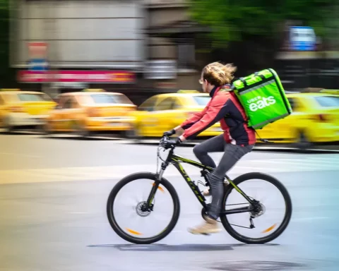 Uber Eats food delivery courier on a bike in high speed