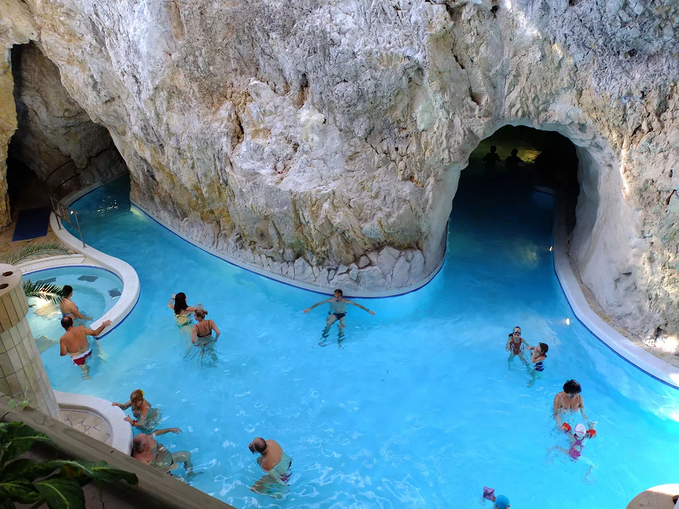 Miskolc Topolca cave baths with hot termal water, made in natural caves. People walk and swim in kind of canals made in the caves and enjoy hot therapeutic water