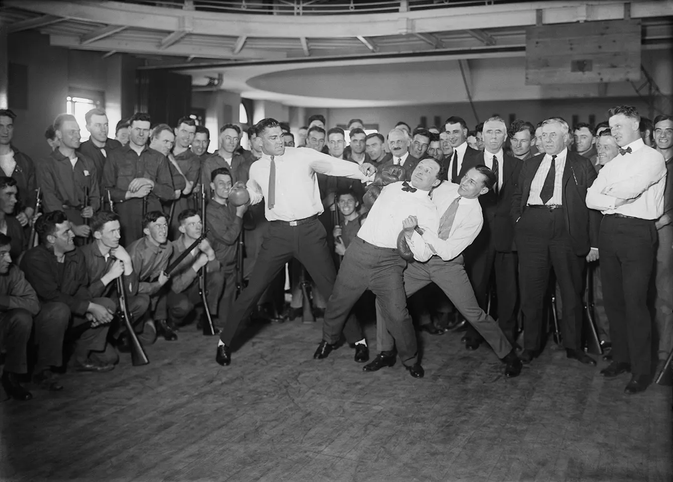 Heavyweight boxer Jack Dempsey mock-punching Houdini