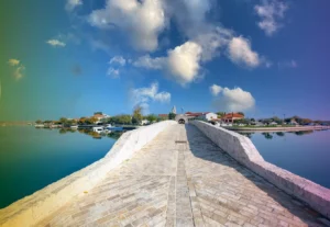 Bridge over the water surrounding the island village of Nim in Croatia