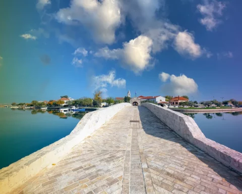 Bridge over the water surrounding the island village of Nim in Croatia