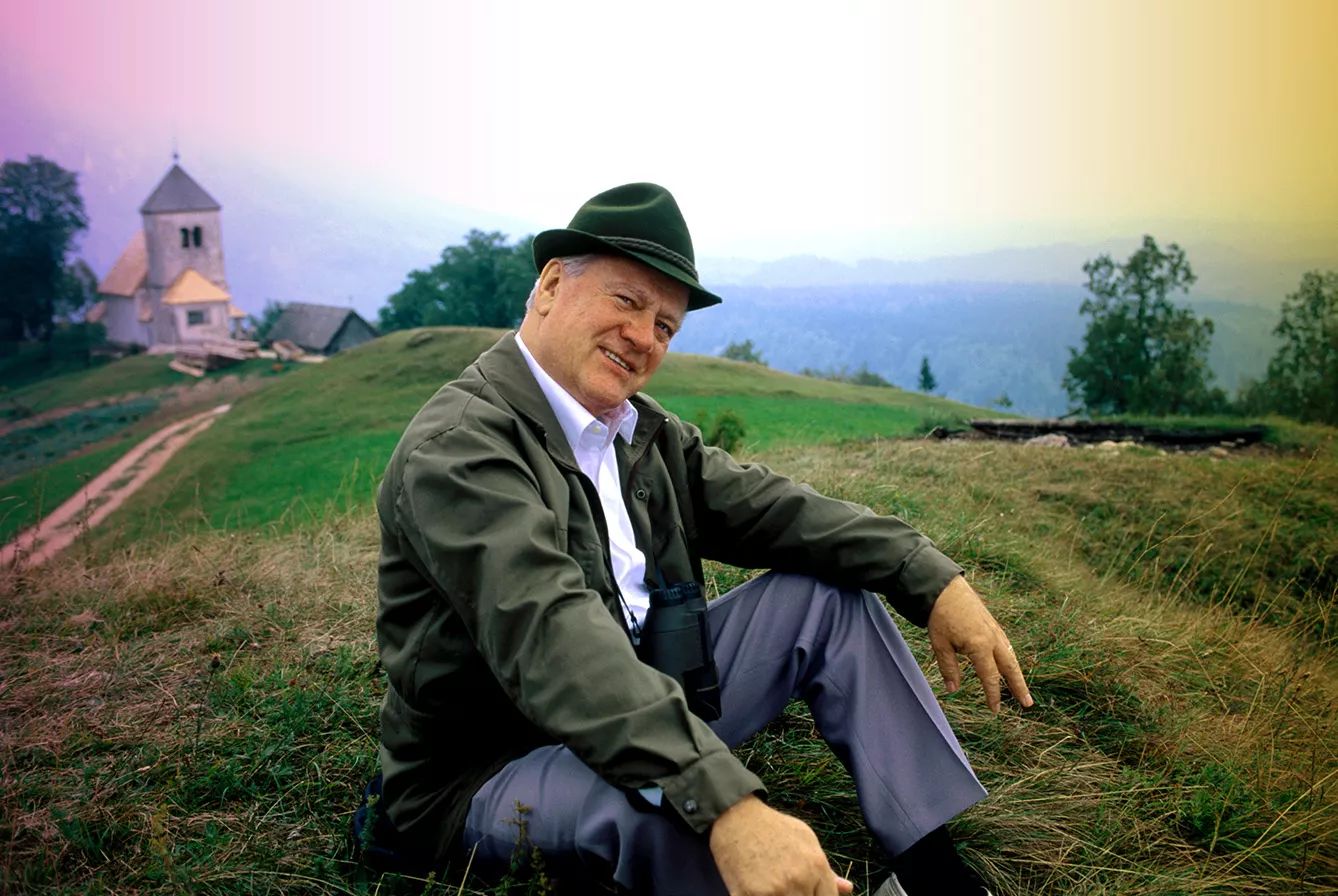Slavko Avsenik sits on grass in the mountain