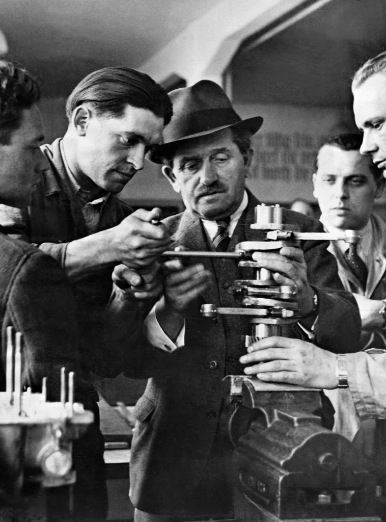 photo of Ferdinand Porsche car designer with workers