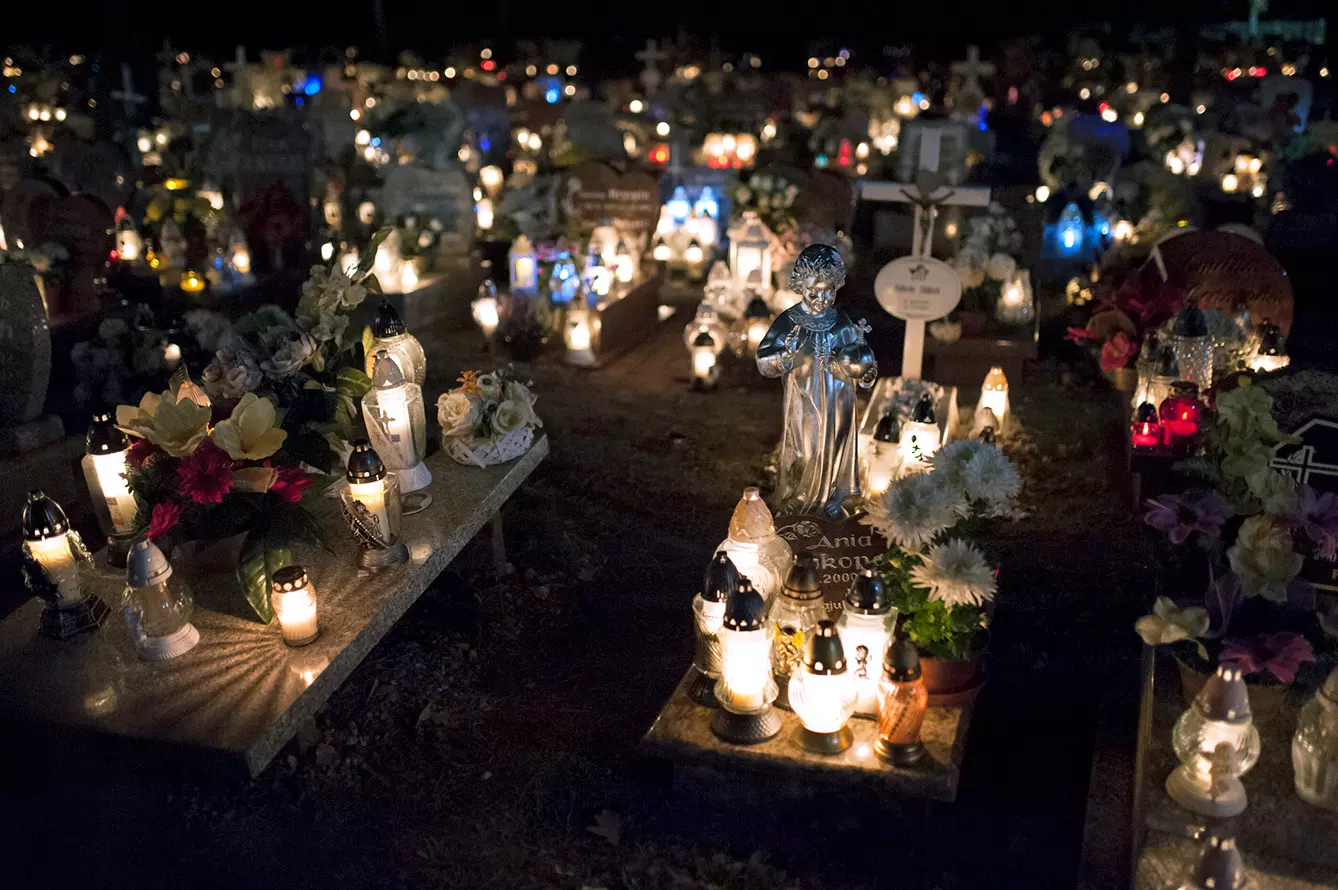 A grave of a child is seen at a cemetery in Kędzierzyn-Koźle decorated with many candles