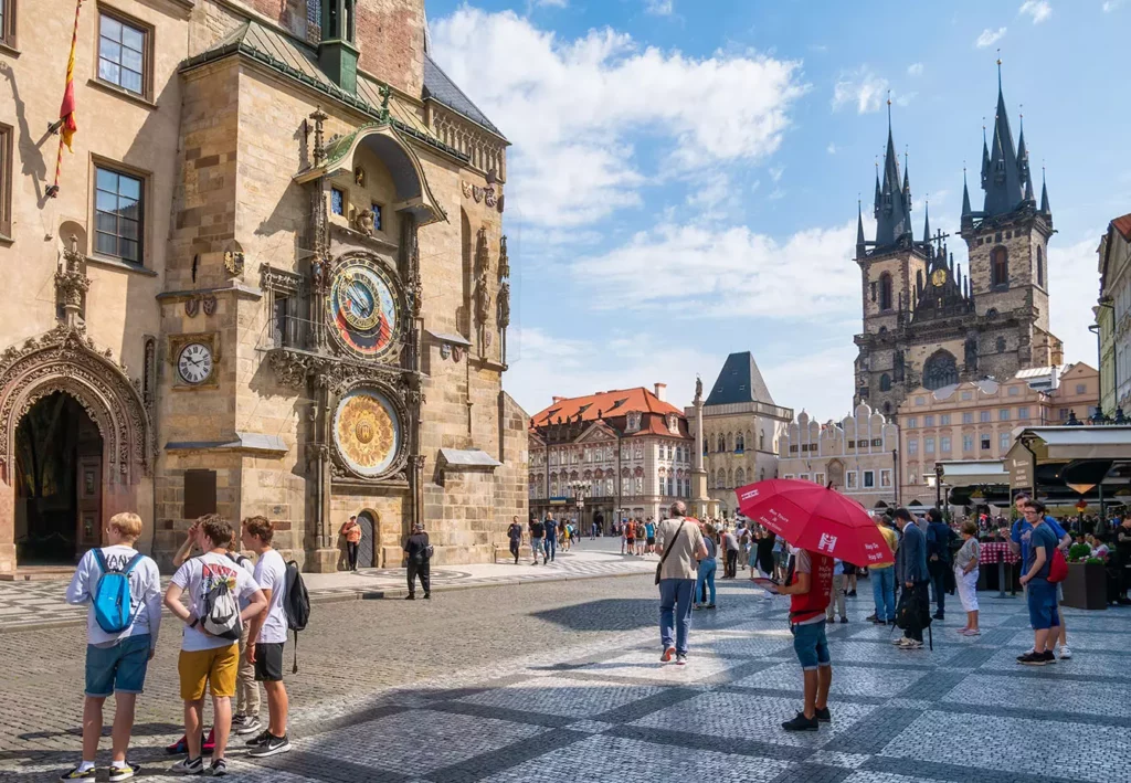 Crowds of people in the old square town of Praguelooking at the Prague Astronomical Clock