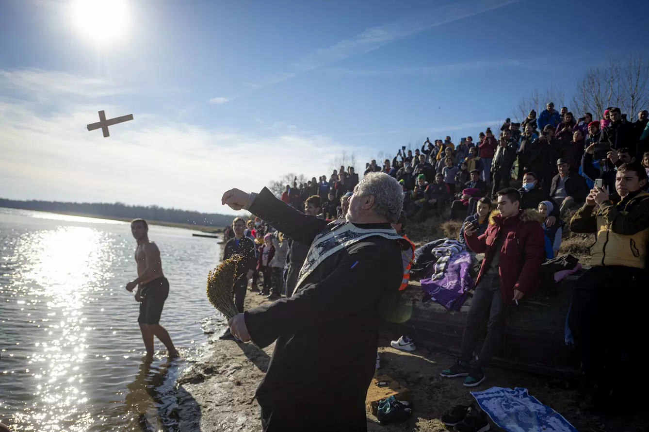 A priest throws a wooden cross in the Danube river during Epiphany celebrations