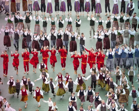 Dancers in traditional costumes perform at the Grand Folk dance concert of Latvian Youth Song and Dance Festival