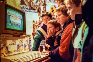 A group of children in a computer shop gathered round an Atari ST