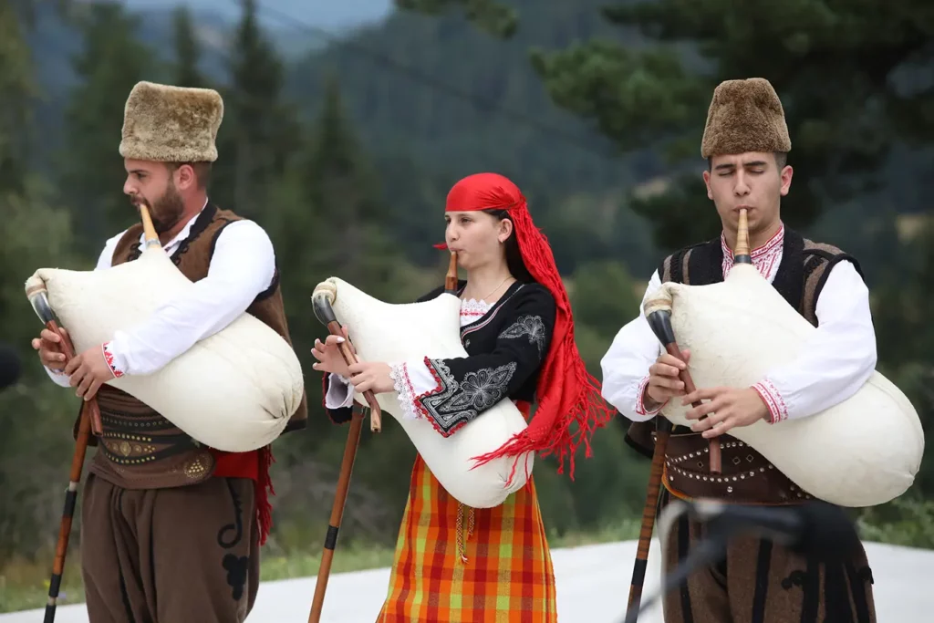 People in traditional folk costume with bagpipe