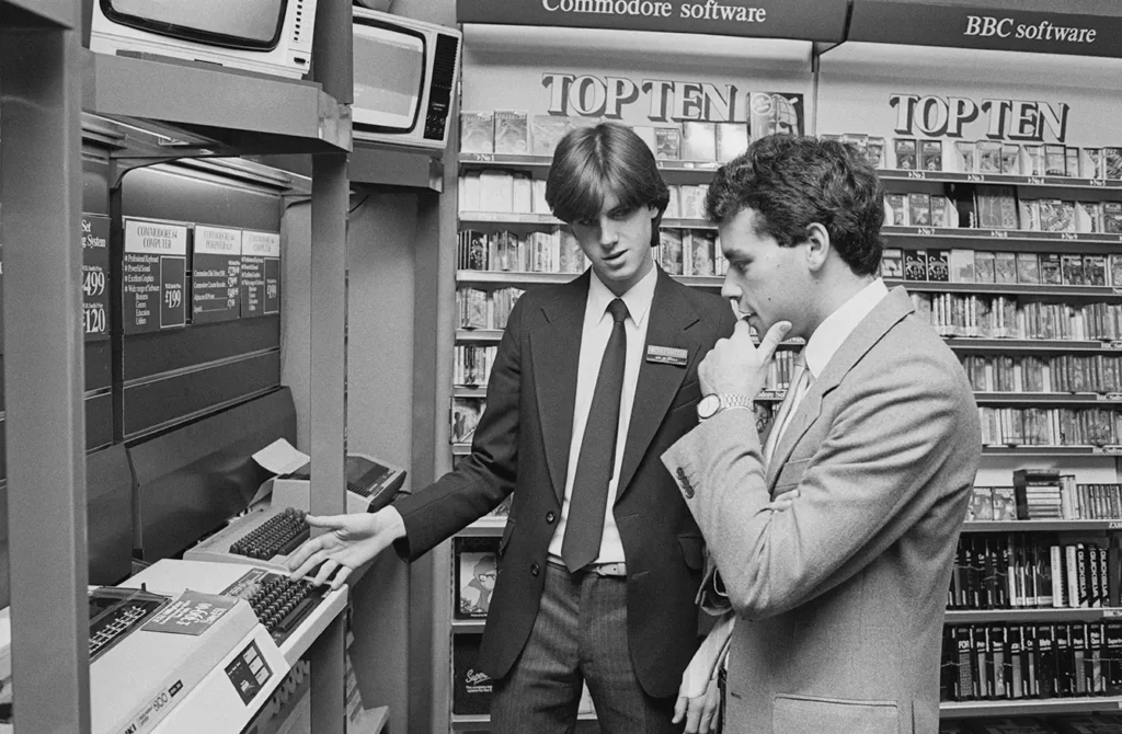 employee helping a costumer in the home computers section at a store
