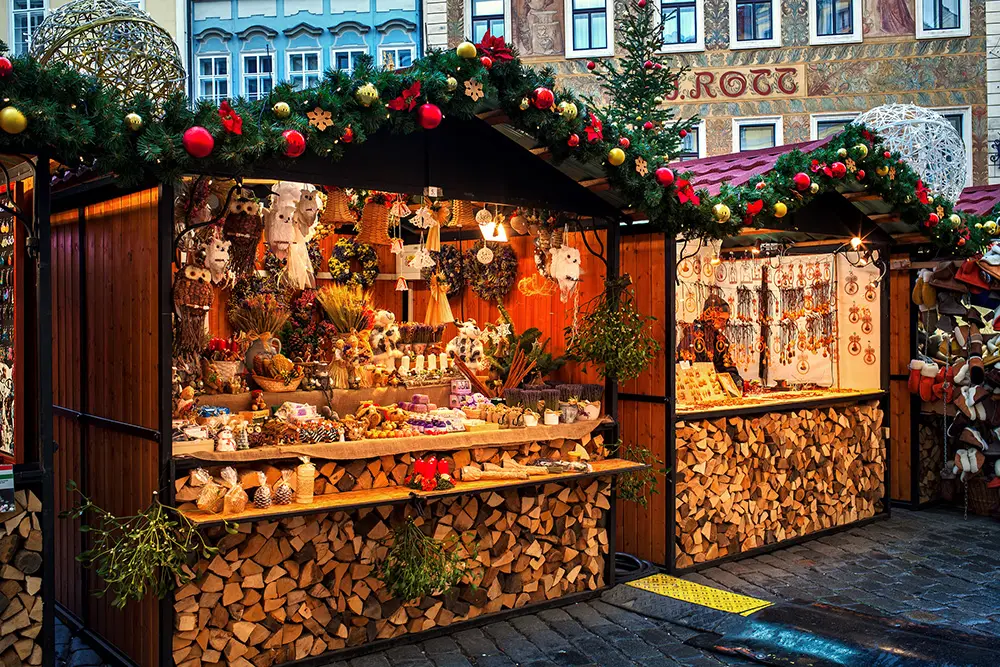 Wooden kiosks offering souvenirs and decorations during Christmas market taking place each year on December. It is very popular destination with tourists visiting Prague.
