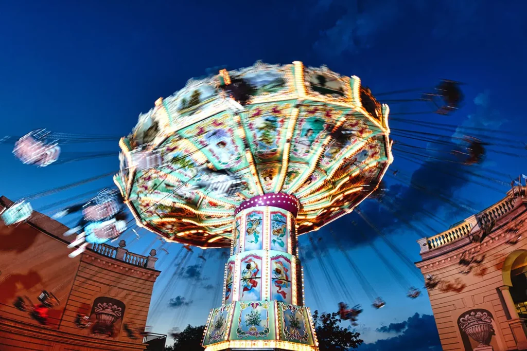 View of a Moving Chain Swing Ride at Dusk in Prater Amusement Park
