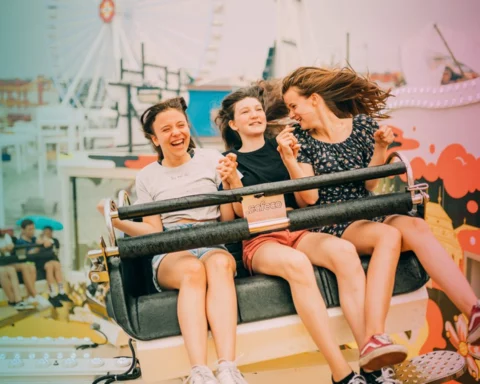 teenagers on carousel at amusement park