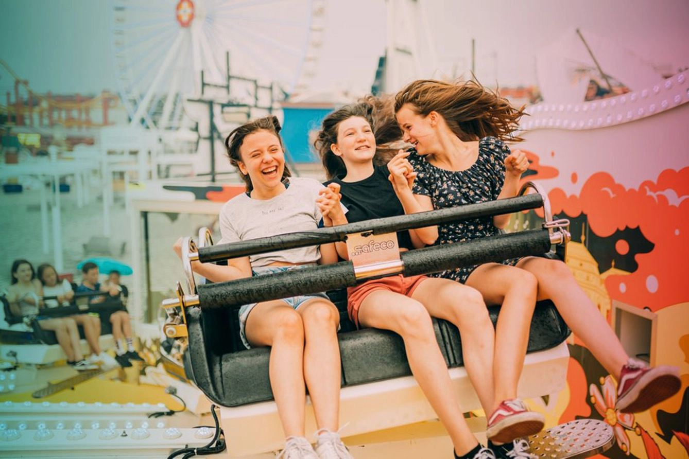 teenagers on carousel at amusement park