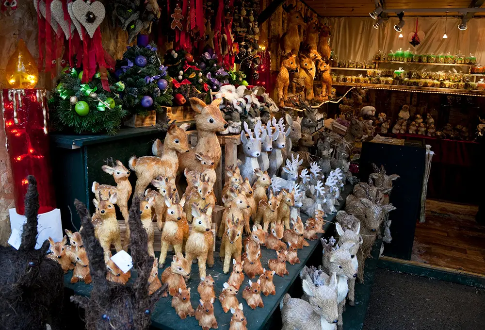 Market stall with reindeer figurines and other christmas ornaments at traditional annual Christmas Market fair in Salzburg, Austria