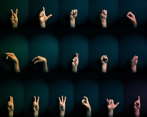Colour image of hands demonstrating ASL sign language letters