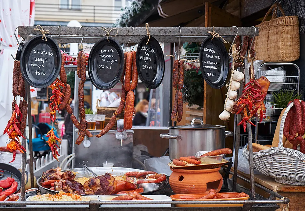 Traditional Croatian food display at the Zagreb Advent market. Sausage Kobasica and Pork hock Buncek are the highlights