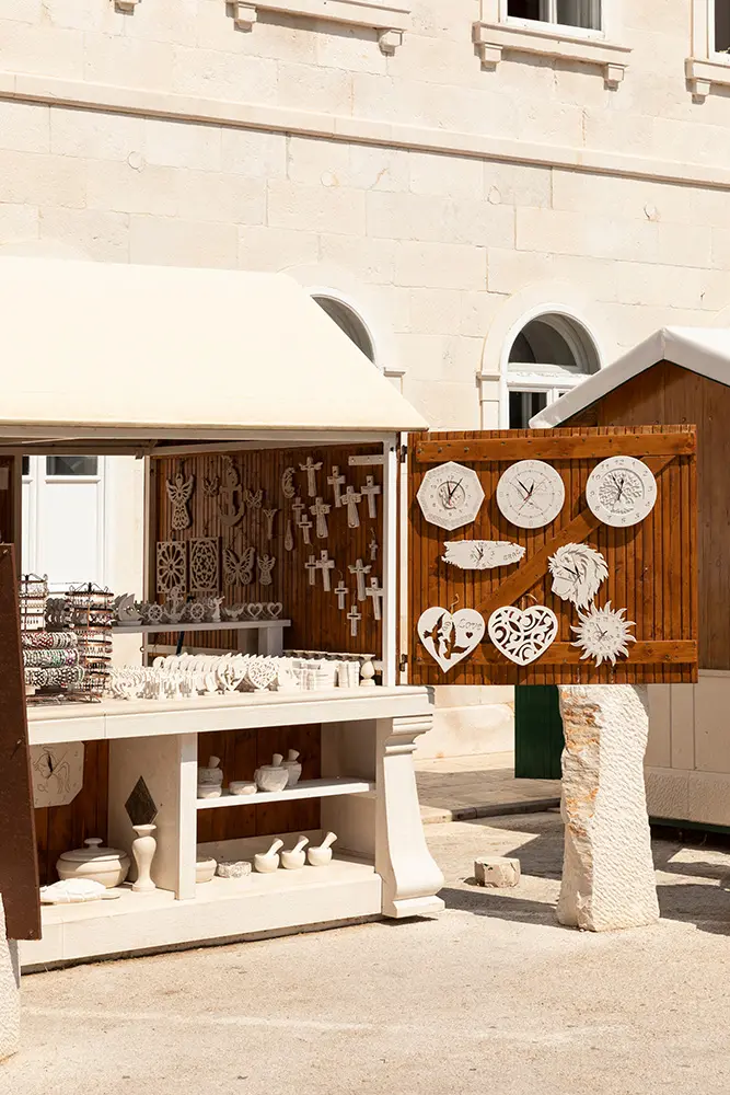 Pucisca, Brac, Croatia, 4th September 2019. View of a souvenir shop in with it’s famous handmade limestone goods. Different clocks and gifts designed and crafted in different sizes and textures
