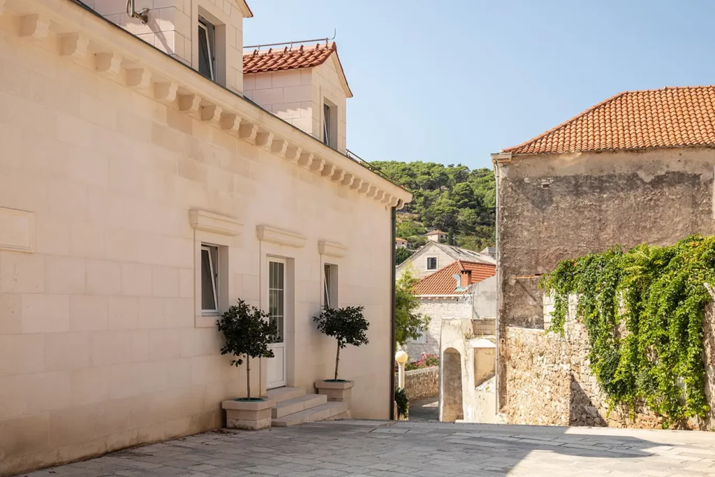 Pucisca, Brac, Croatia, 4th September 2019. View of a street on the island on a sunny day in summer with a blue sky. The facades of the buildings made with the famous white limestone. Idyllic place