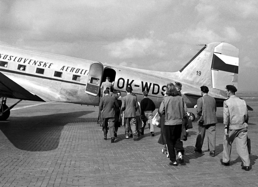 Boarding the plane to a shuttle service between Prague and Marianske Lazna. Black and white photo from 1950