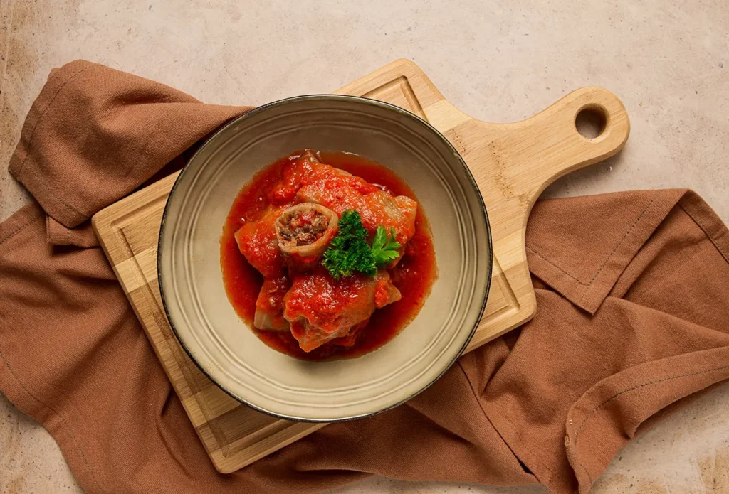 Stuffed cabbage rolls, with minced meat, in tomato sauce, on a beige background, food and drink, healthy eating, healthy lifestyle, cuisine, rustic, cabbage roll, top view, no people