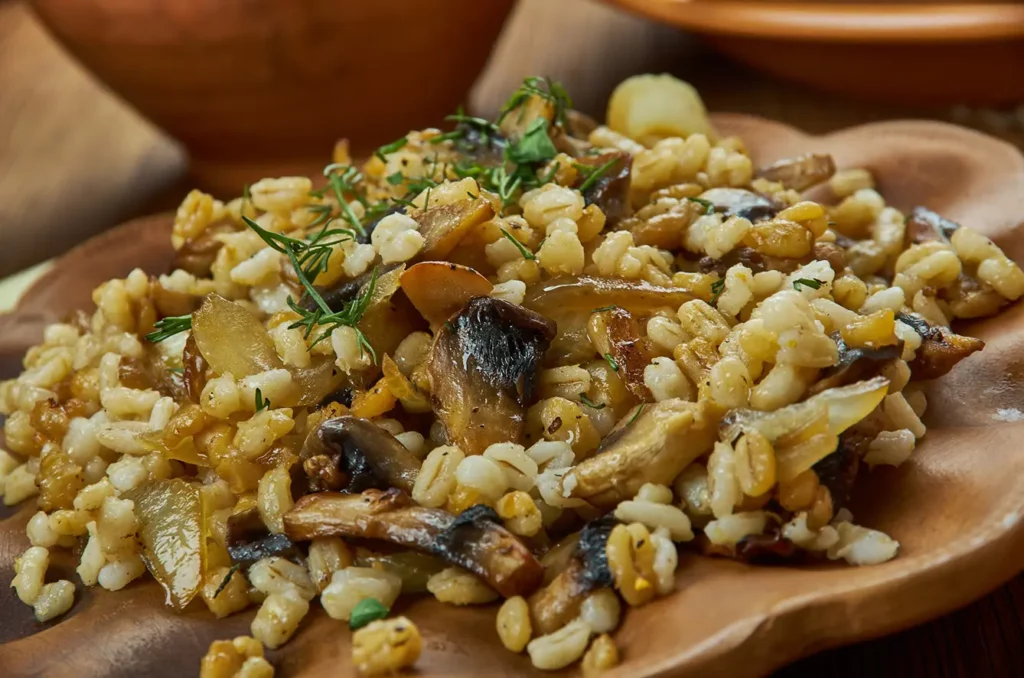 Houbovy kuba, Made from mushrooms, barley, caramelized onions, and garlic, and spiced with marjoram and caraway, Czech cuisine, Traditional assorted dishes, Top view.