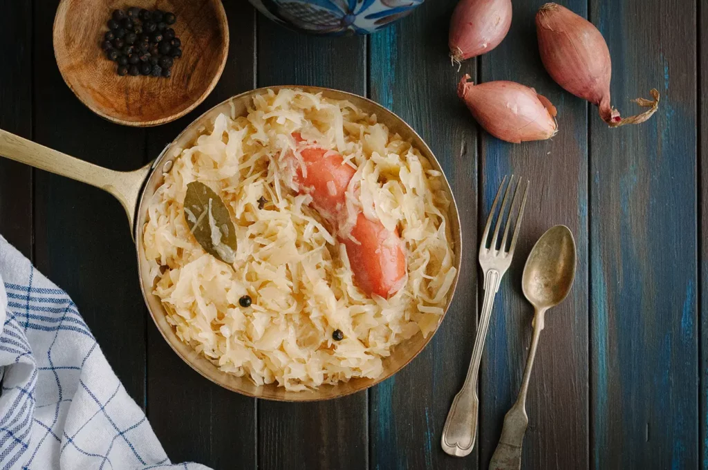 Copper pan with sauerkraut and sausage