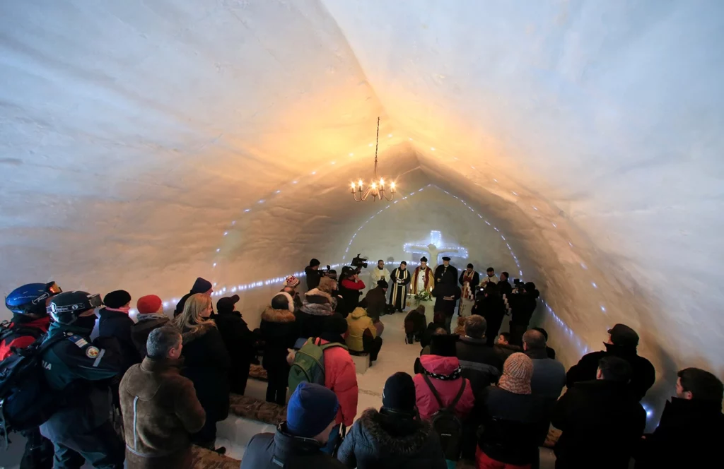 A group of priests of various congregations hold an inaugural mass for a church made entirely from ice at Balea Lac resort in the Fagaras mountains