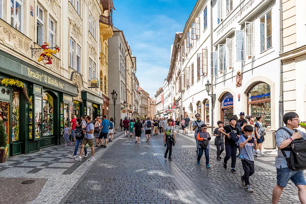 People walking and typical shops in the street Celetna in the old city of Prague