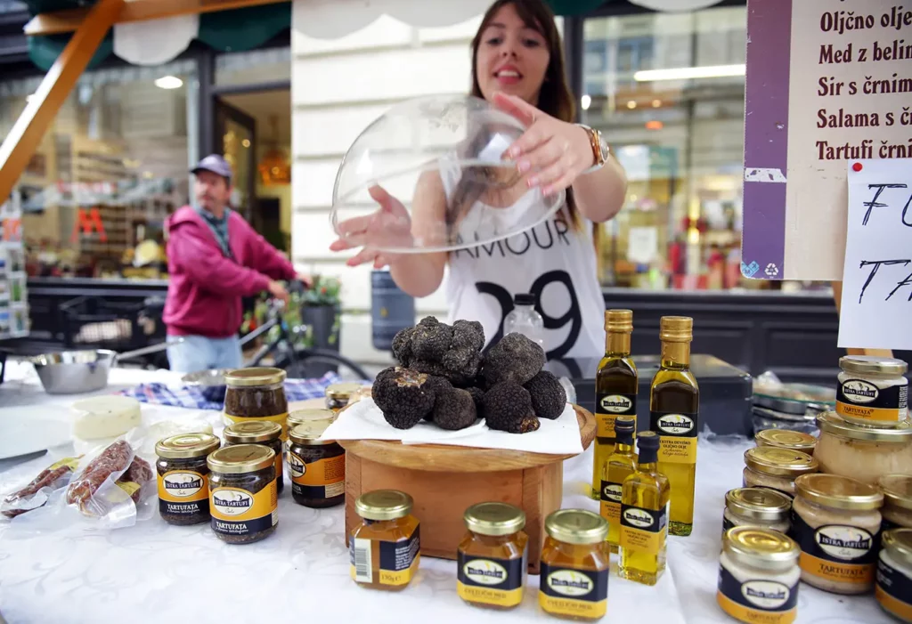 A vendor arranges fresh black truffles on her stall at an organic food and drink festival in Ljubljana, Slovenia