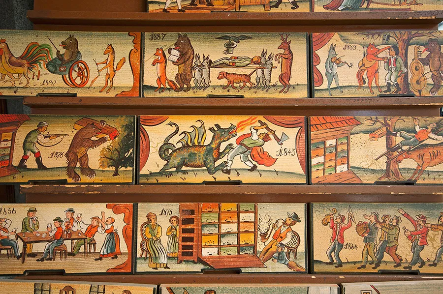 Traditional painted wooden tablets used to decorate bee hives for sale at the market in Ljubljana, Slovenia
