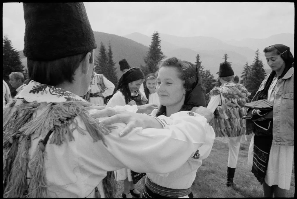 black and white photo of couple in traditional romanian dress dancing
