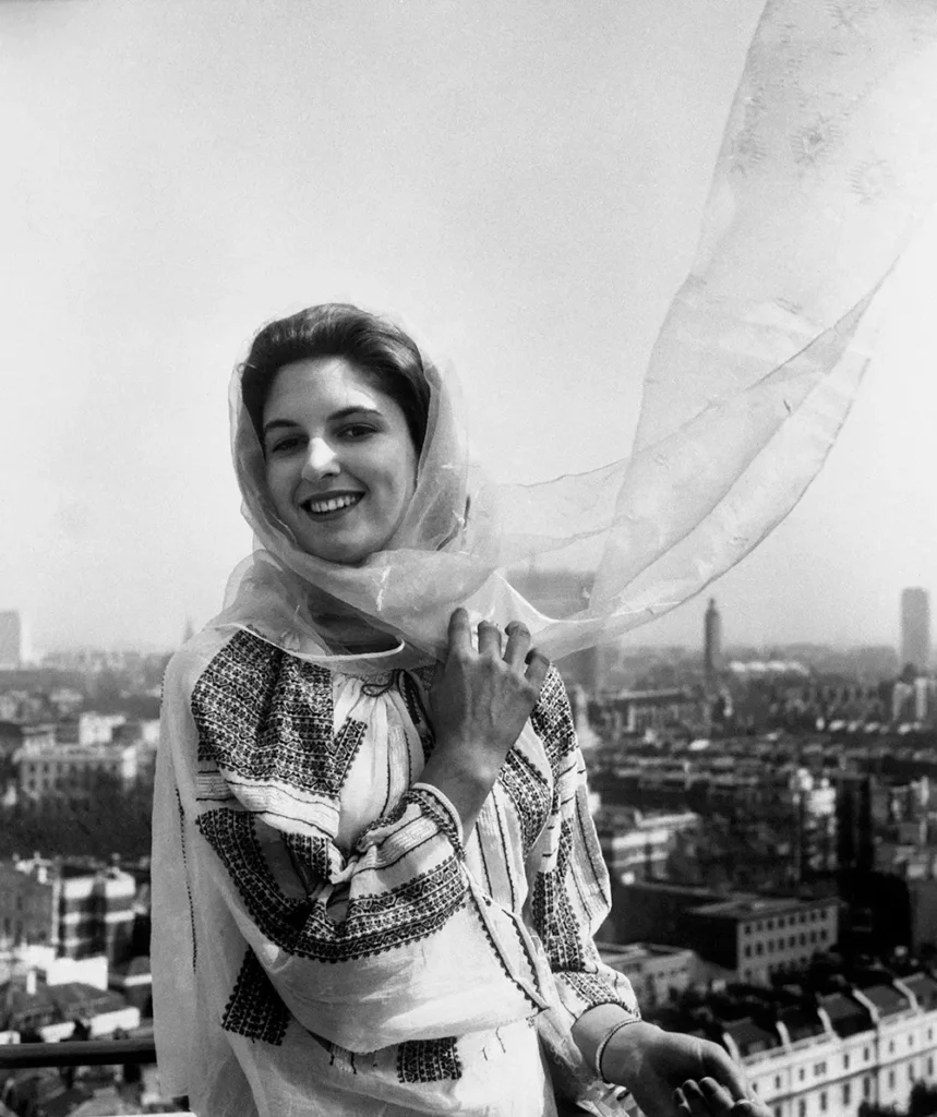 woman in hand-worked Romanian peasant blouse and scarf on archive photo from 1962